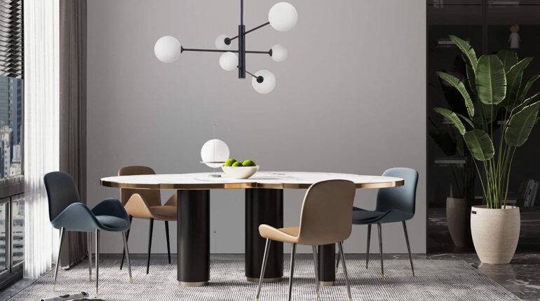 Gdzie lepiej zamawiać lampy - w sklepie internetowym czy stacjonarnym?- Salon z lampą wiszącą nad stołem.